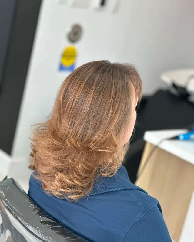 Warm strawberry-blonde layers with movement through the ends